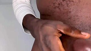 A handsome man of average height pleasuring himself and releasing a large amount of semen